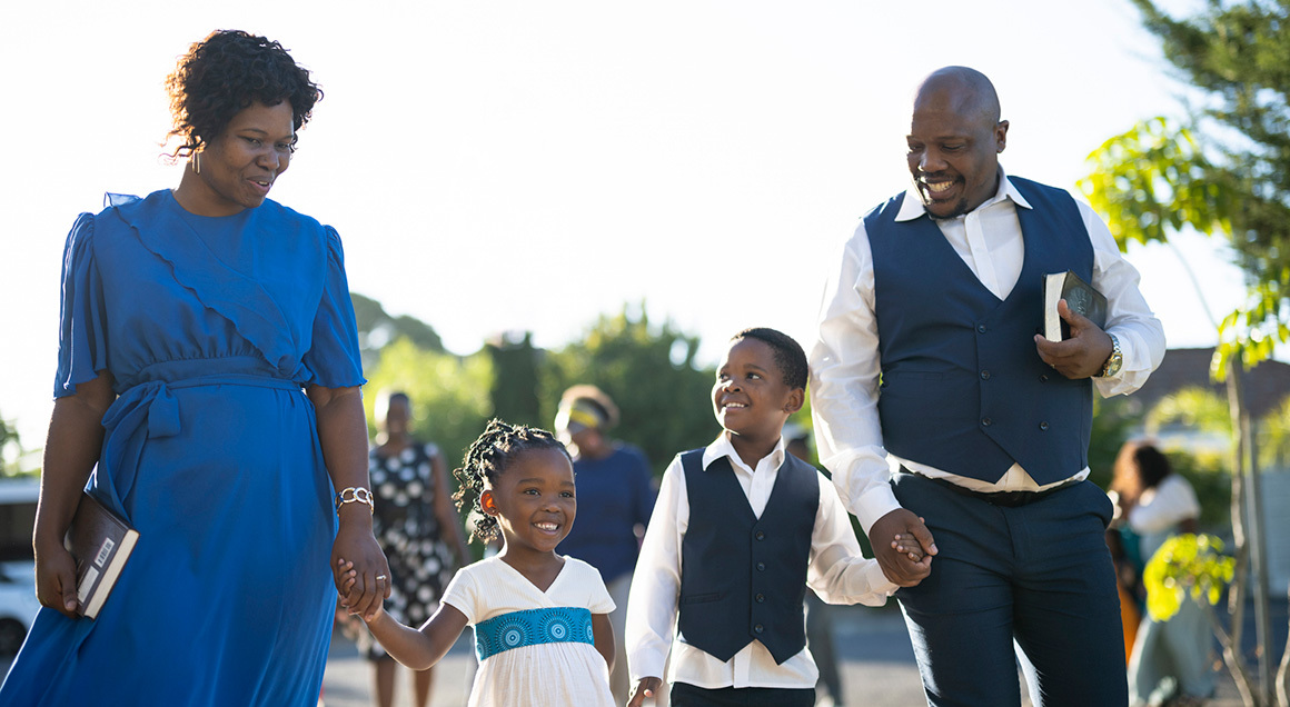 African American family walking into church