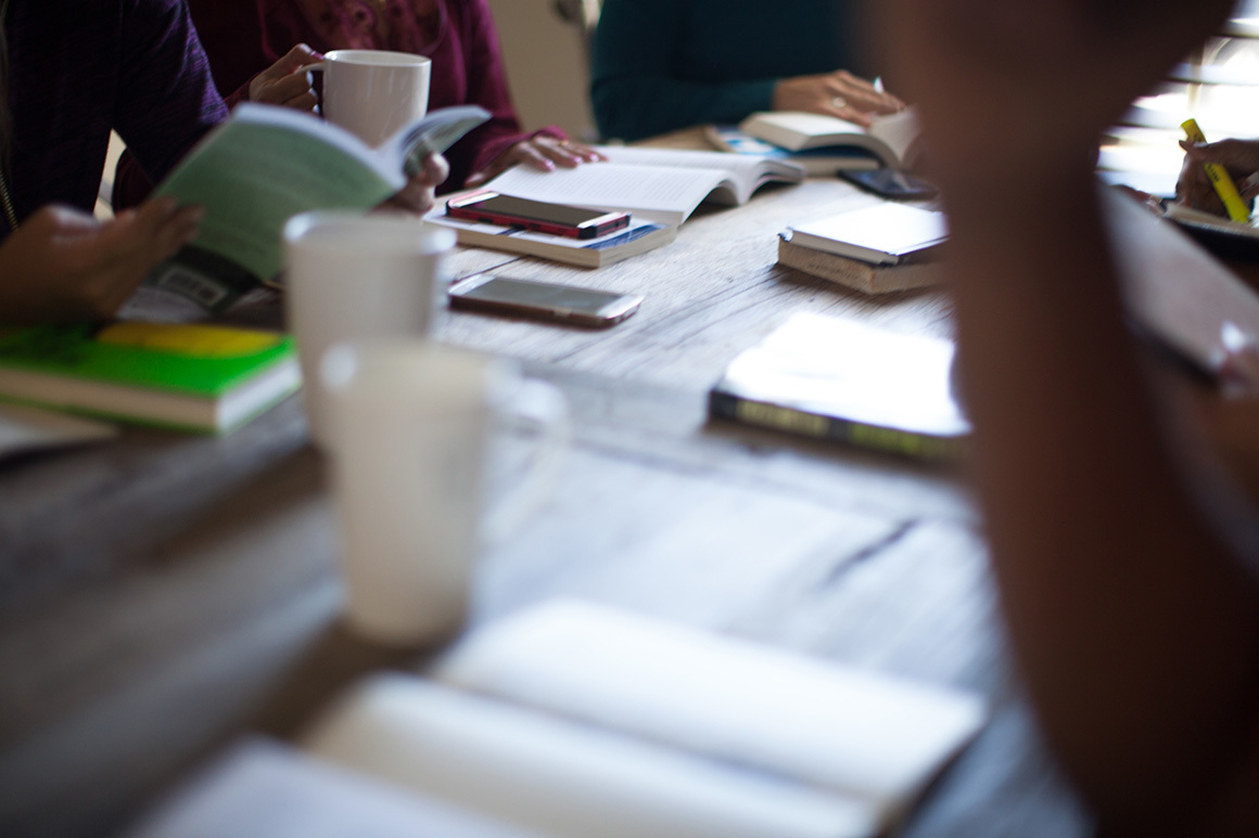 Stock small group gathered around table