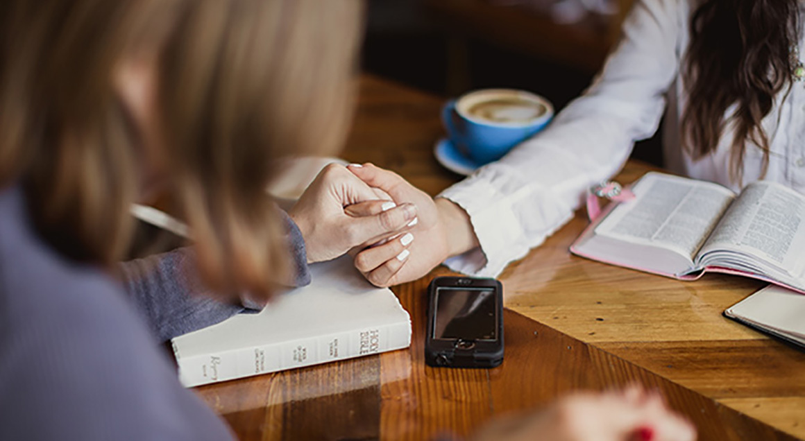 Stock women holding hands spiritual gifts