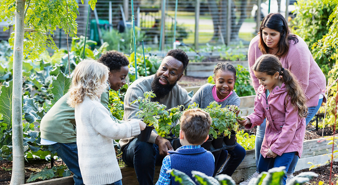 Teachers and students in greenhouse